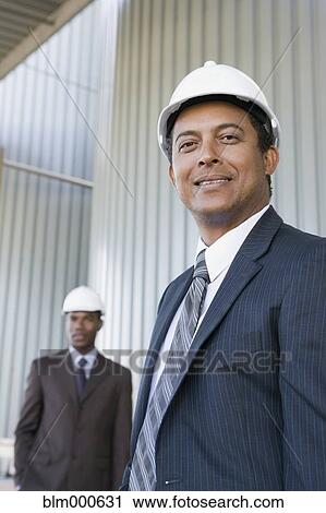 Multi-ethnic businessmen in hard-hats View Large Photo Image Stock Image - Multi-ethnic businessmen in hard-hats. Fotosearch
