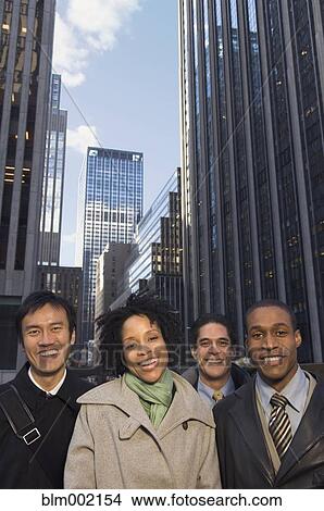Picture - Multi-ethnic businesspeople in urban scene. Fotosearch