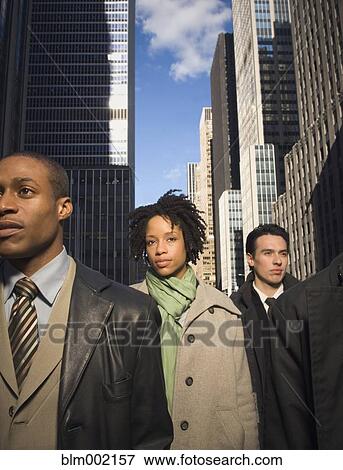 Stock Photo - Multi-ethnic businesspeople in urban scene. Fotosearch