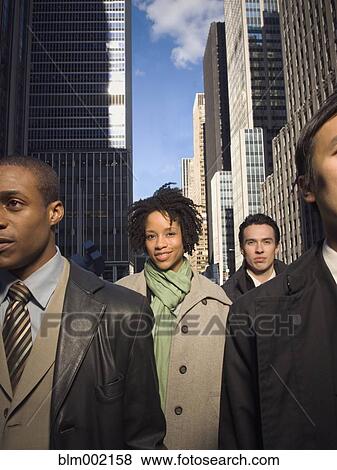 Stock Photo - Multi-ethnic businesspeople in urban scene. Fotosearch