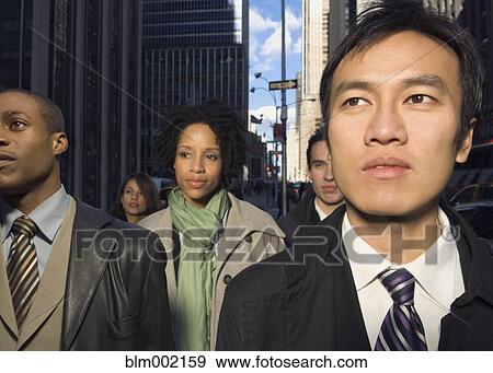 Stock Photo - Multi-ethnic businesspeople in urban scene. Fotosearch