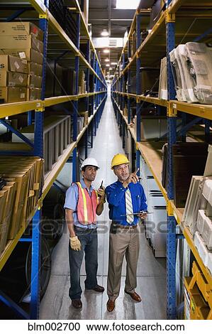 Multi-ethnic co-workers in warehouse View Large Photo Image Stock Image - Multi-ethnic co-workers in warehouse. Fotosearch
