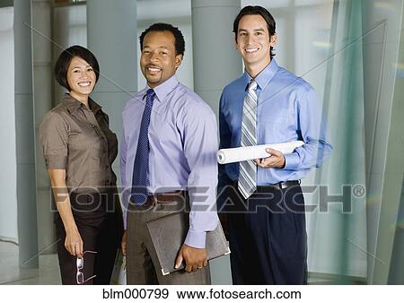 Stock Photo - Multi-ethnic co-workers posing in office. Fotosearch