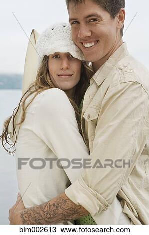 Stock Image - Multi-ethnic couple hugging. Fotosearch