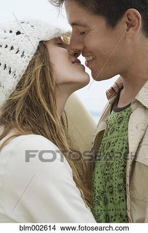 Multi-ethnic couple kissing View Large Photo Image Picture - Multi-ethnic couple kissing. Fotosearch