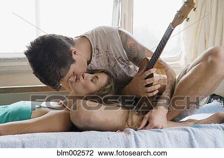 Stock Image - Multi-ethnic couple kissing. Fotosearch