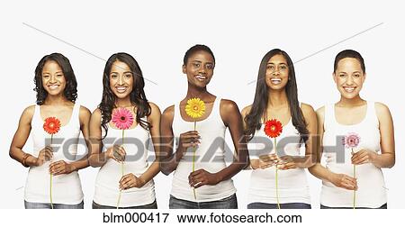 Stock Photo - Multi-ethnic friends holding daisies. Fotosearch