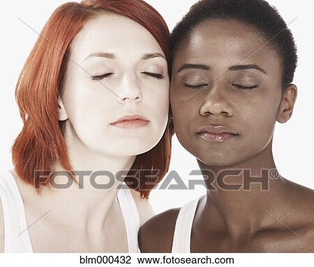 Stock Image - Multi-ethnic friends hugging with eyes closed. Fotosearch