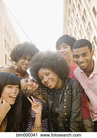 Stock Image - Multi-ethnic friends smiling. Fotosearch