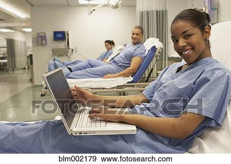 Multi-ethnic medical professionals in hospital beds View Large Photo Image Stock Photo - Multi-ethnic medical professionals in hospital beds. Fotosearch