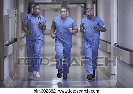Multi-ethnic medical professionals running in hallway View Large Photo Image Stock Image - Multi-ethnic medical professionals running in hallway. Fotosearch