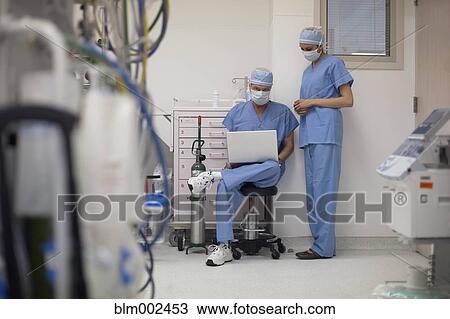 Multi-ethnic medical professionals looking at laptop View Large Photo Image Stock Image - Multi-ethnic medical professionals looking at laptop. Fotosearch