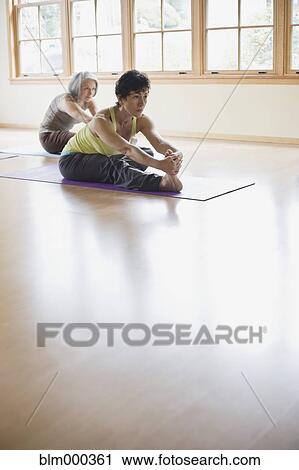 Stock Image - Multi-ethnic women in yoga class. Fotosearch