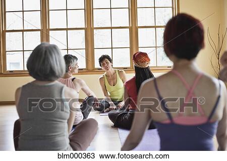 Stock Image - Multi-ethnic women in yoga class. Fotosearch