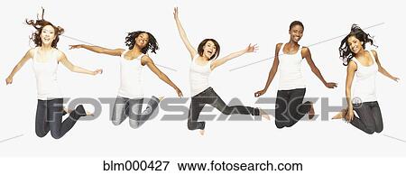 Multi-ethnic women jumping in mid-air View Large Photo Image Stock Photo - Multi-ethnic women jumping in mid-air. Fotosearch