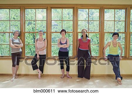 Stock Image - Multi-ethnic women standing in sportswear. Fotosearch