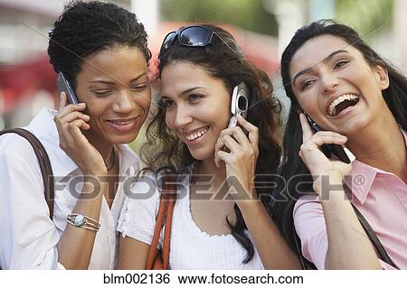 Stock Photograph - Multi-ethnic women talking on cell phones. Fotosearch