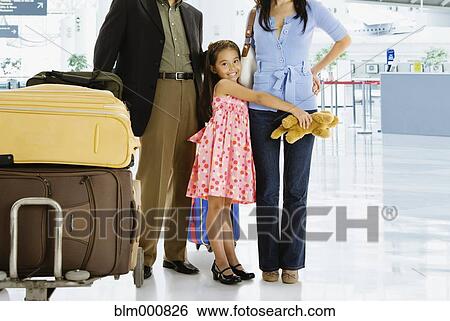 Stock Photograph - Multi-generational Asian family posing in airport. Fotosearch