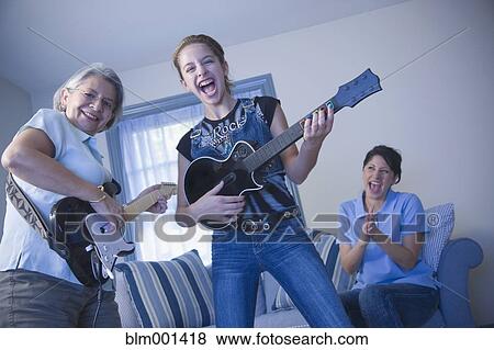 Multi-generational family playing guitars View Large Photo Image Stock Photo - Multi-generational family playing guitars. Fotosearch