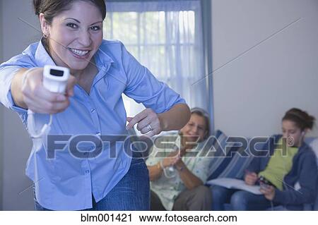 Multi-generational family playing video game View Large Photo Image Stock Image - Multi-generational family playing video game. Fotosearch