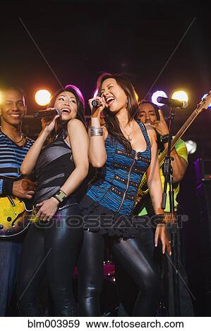 Stock Photo - Musical group performing onstage. Fotosearch