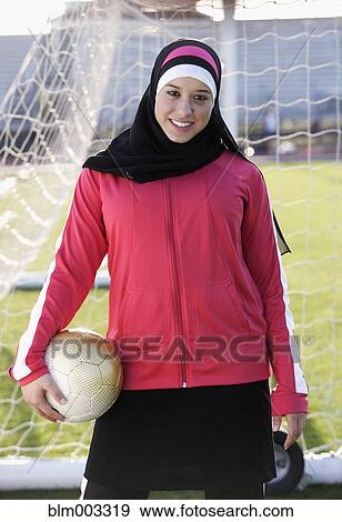 Stock Photo - Muslim teenager holding soccer ball. Fotosearch
