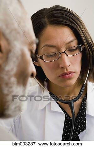 Native American doctor examining patient View Large Photo Image Stock Photo - Native American doctor examining patient. Fotosearch
