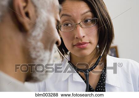 Stock Photo - Native American doctor examining patient. Fotosearch