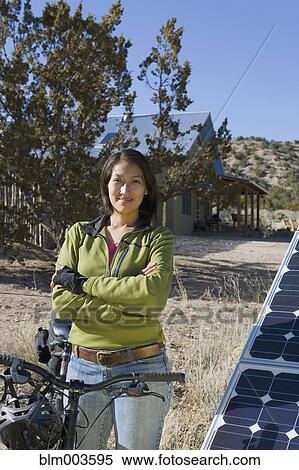 Native American woman with bicycle near solar panels View Large Photo Image Stock Photography - Native American woman with bicycle near solar panels. Fotosearch
