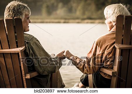 Stock Photo - Older Caucasian couple sitting outdoors. Fotosearch