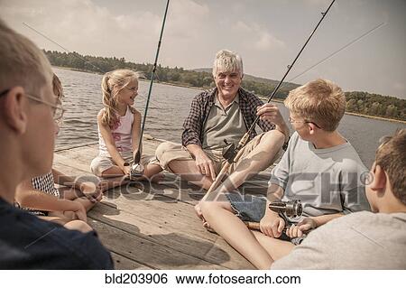 Older Caucasian man teaching grandchildren to fish View Large Photo Image Stock Photograph - Older Caucasian man teaching grandchildren to fish. Fotosearch