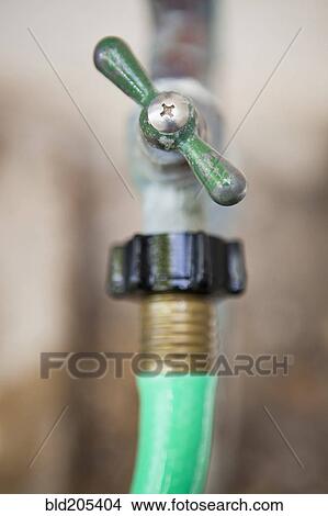 Outdoor faucet and hose View Large Photo Image Picture - Outdoor faucet and hose. Fotosearch