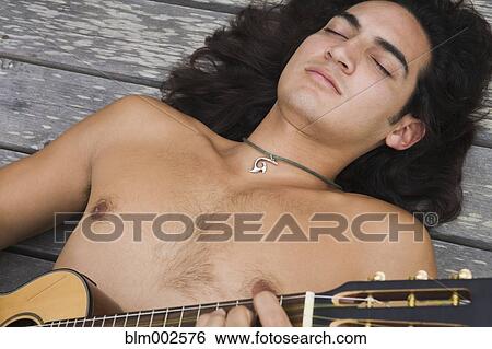 Pacific Islander man holding ukulele View Large Photo Image Stock Photograph - Pacific Islander man holding ukulele. Fotosearch