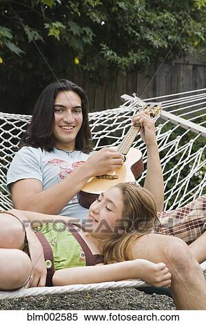 Pacific Islander man playing ukulele for sister View Large Photo Image Stock Photography - Pacific Islander man playing ukulele for sister. Fotosearch