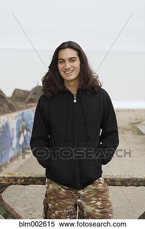 Stock Photography - Pacific Islander man with hands in pockets. Fotosearch