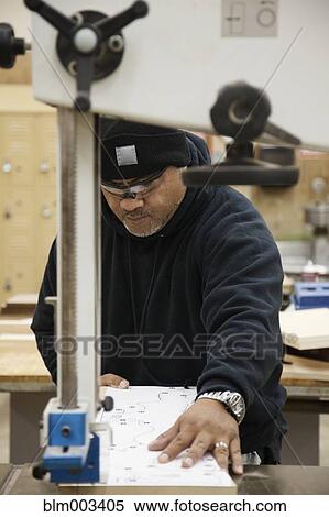 Stock Photography - Pacific Islander man working in workshop. Fotosearch