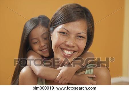 Pacific Islander mother and daughter hugging View Large Photo Image Stock Photo - Pacific Islander mother and daughter hugging. Fotosearch