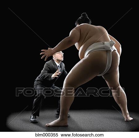 Stock Photography - Pacific Islander sumo wrestler challenging businessman. Fotosearch