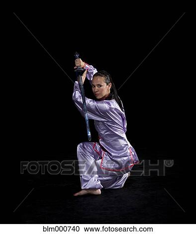 Pacific Islander woman practicing martial arts with sword View Large Photo Image Stock Image - Pacific Islander woman practicing martial arts with sword. Fotosearch
