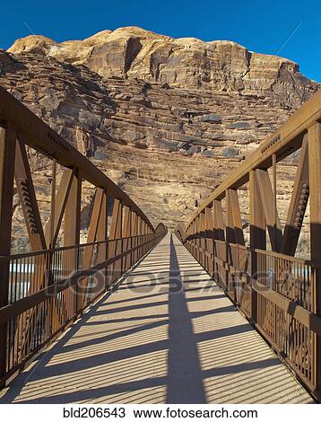 Stock Image - Pedestrian Bridge With a Rocky Background. Fotosearch