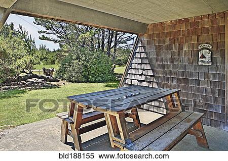 Stock Photography - Picnic table in backyard of modern house. Fotosearch