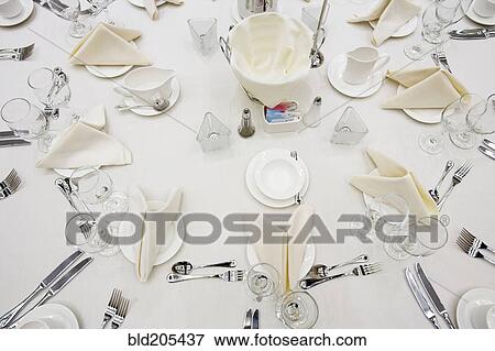 Stock Photo - Place settings on round table. Fotosearch
