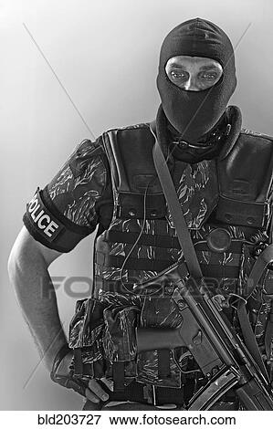 Policeman wearing machine gun and vest View Large Photo Image Stock Photo - Policeman wearing machine gun and vest. Fotosearch