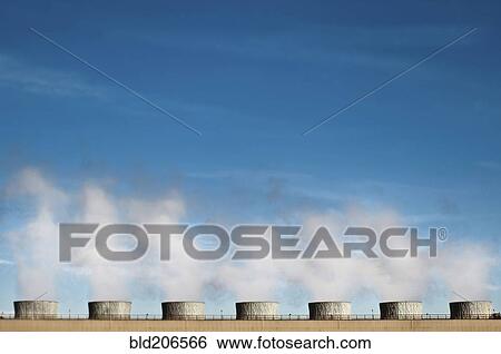 Pollution emitting from cooling towers View Large Photo Image Stock Photograph - Pollution emitting from cooling towers. Fotosearch