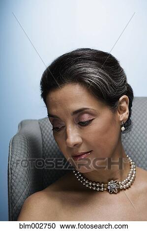 Stock Image - Portrait of Hispanic woman looking down. Fotosearch