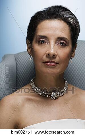 Stock Image - Portrait of Hispanic woman looking serious. Fotosearch