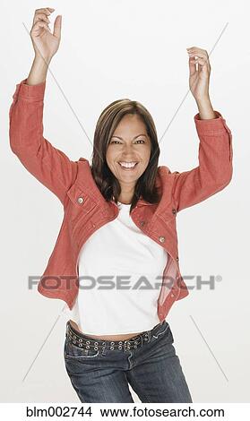 Picture - Portrait of Hispanic woman smiling with arms raised. Fotosearch