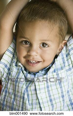 Stock Image - Portrait of smiling mixed race boy. Fotosearch