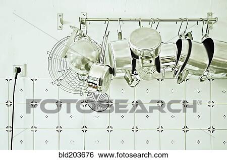 Pots and pans hanging in kitchen View Large Photo Image Stock Photograph - Pots and pans hanging in kitchen. Fotosearch