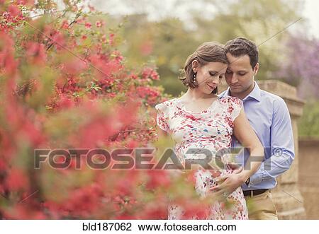Pregnant Caucasian couple hugging outdoors View Large Photo Image Stock Image - Pregnant Caucasian couple hugging outdoors. Fotosearch